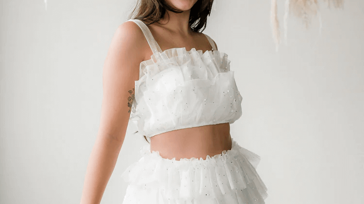 woman wearing a white tulle skirt set and headband