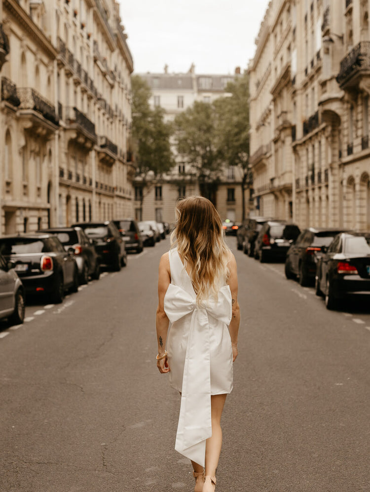 white satin sheath mini dress with bow back for engagement photo dress for bride shot in paris