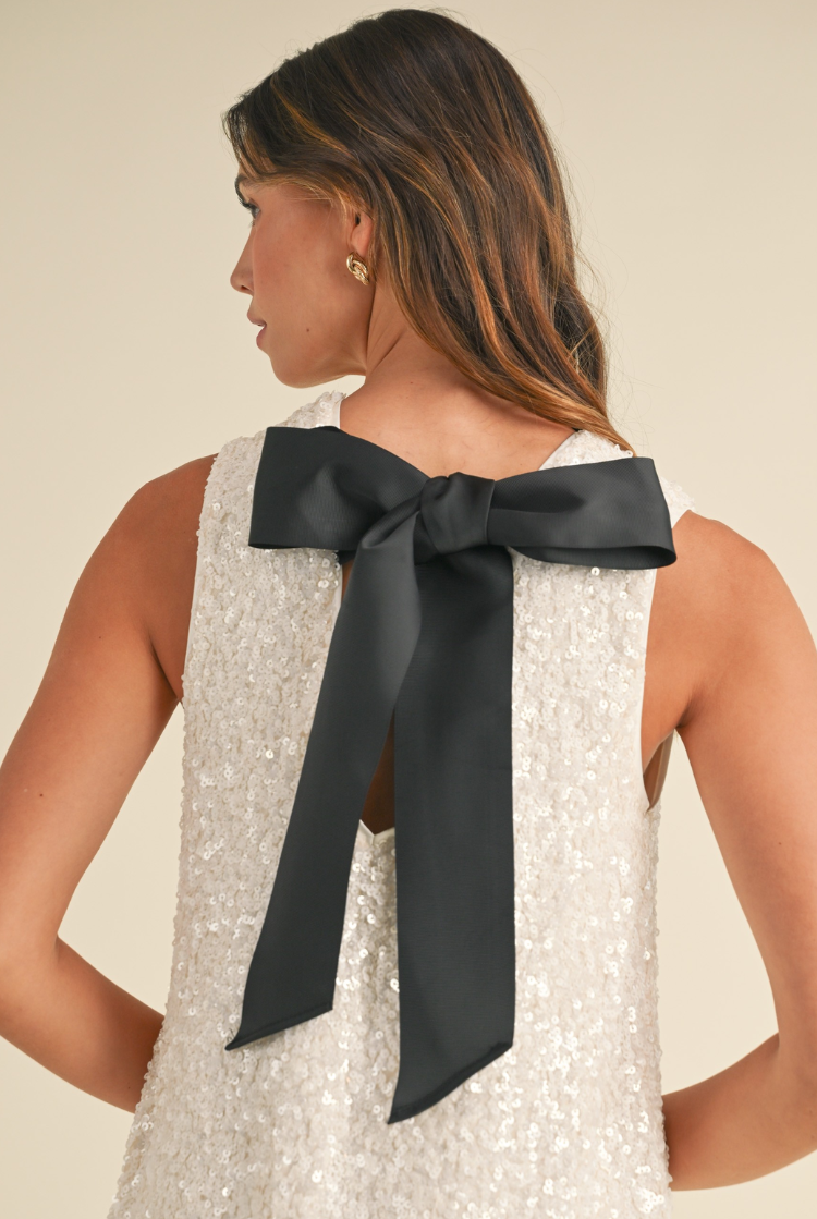 white sequin mini dress with black bow tie
