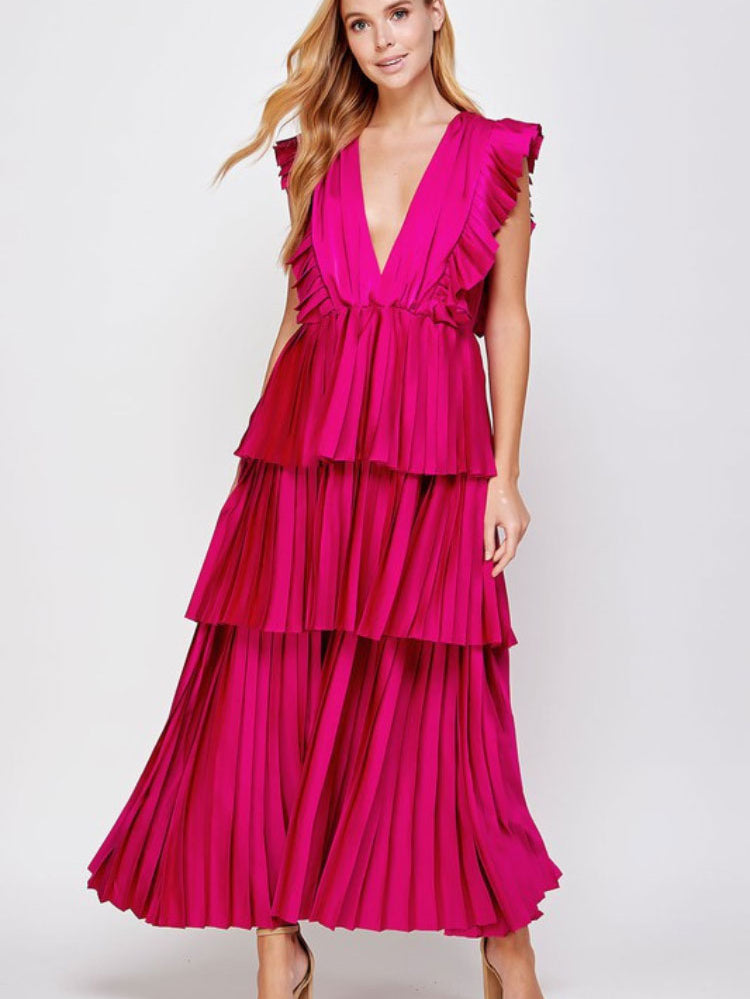 a model in a pink tiered maxi dress facing the front.