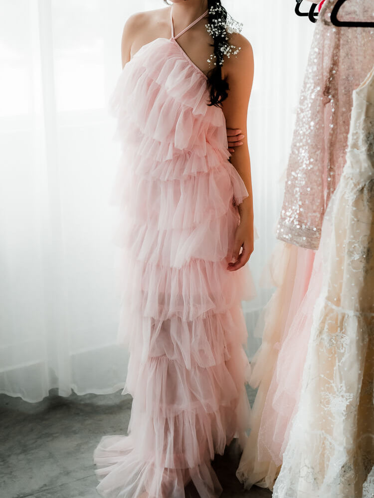 a neck-down photo of a model in a pink tulle dress.