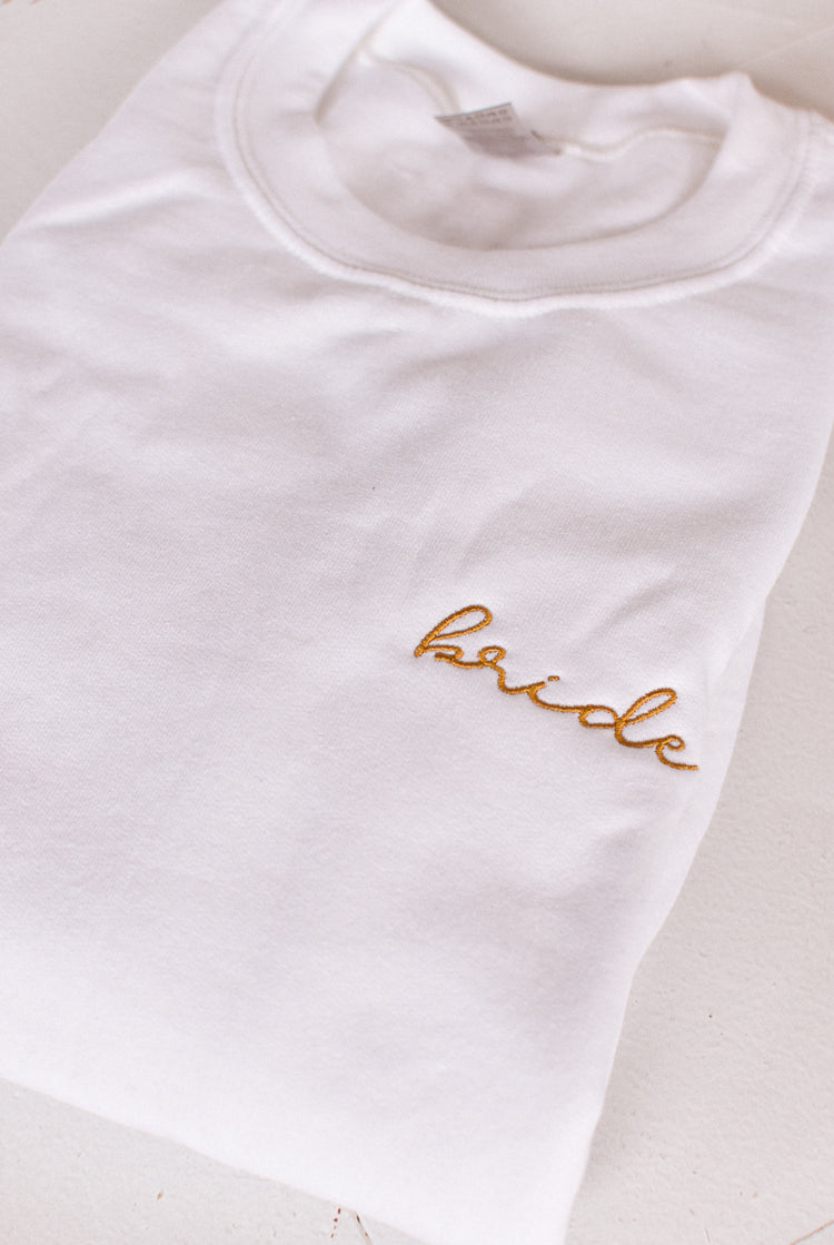 white sweatshirt with gold embroidered bride