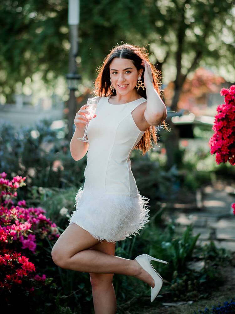 model wearing a white feather mini dress