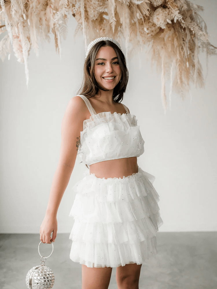 woman wearing a white tulle skirt set and headband
