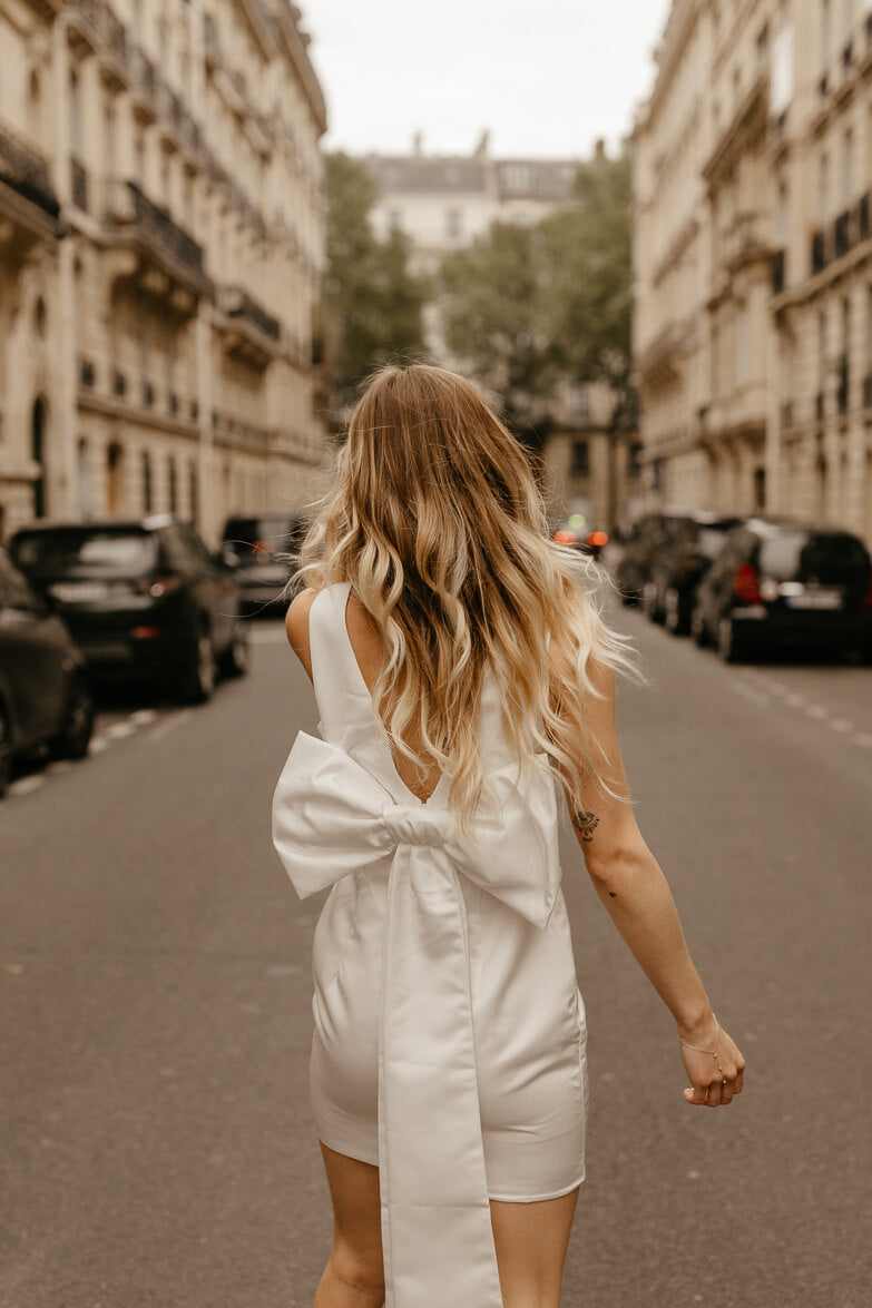 white satin sheath mini dress with bow back for engagement photo dress for bride shot in paris