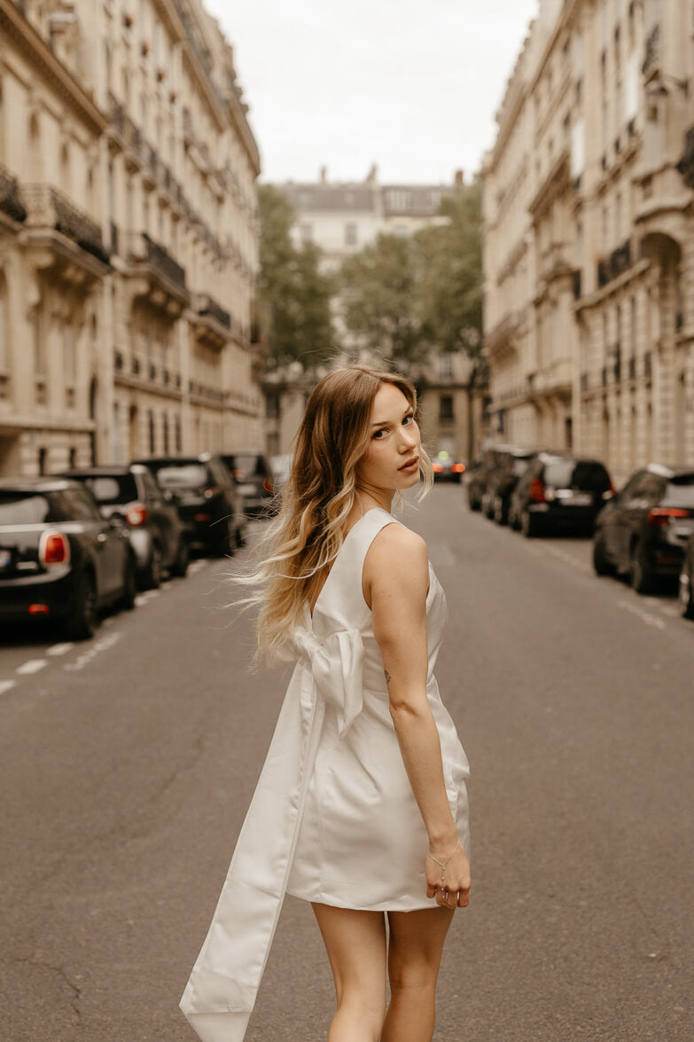 white satin sheath mini dress with bow back for engagement photo dress for bride shot in paris