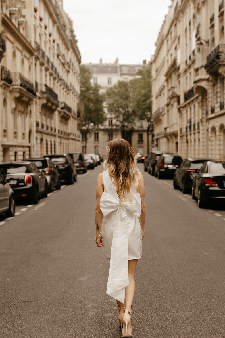 white satin sheath mini dress with bow back for engagement photo dress for bride shot in paris