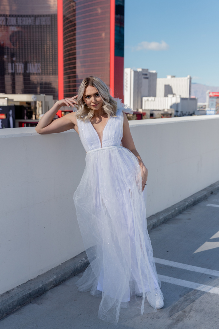 white tulle maxi dress with deep v and decorative shoulder detail