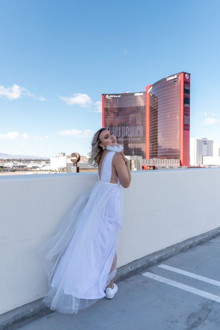 white tulle maxi dress with deep v and decorative shoulder detail