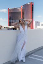 white tulle maxi dress with deep v and decorative shoulder detail