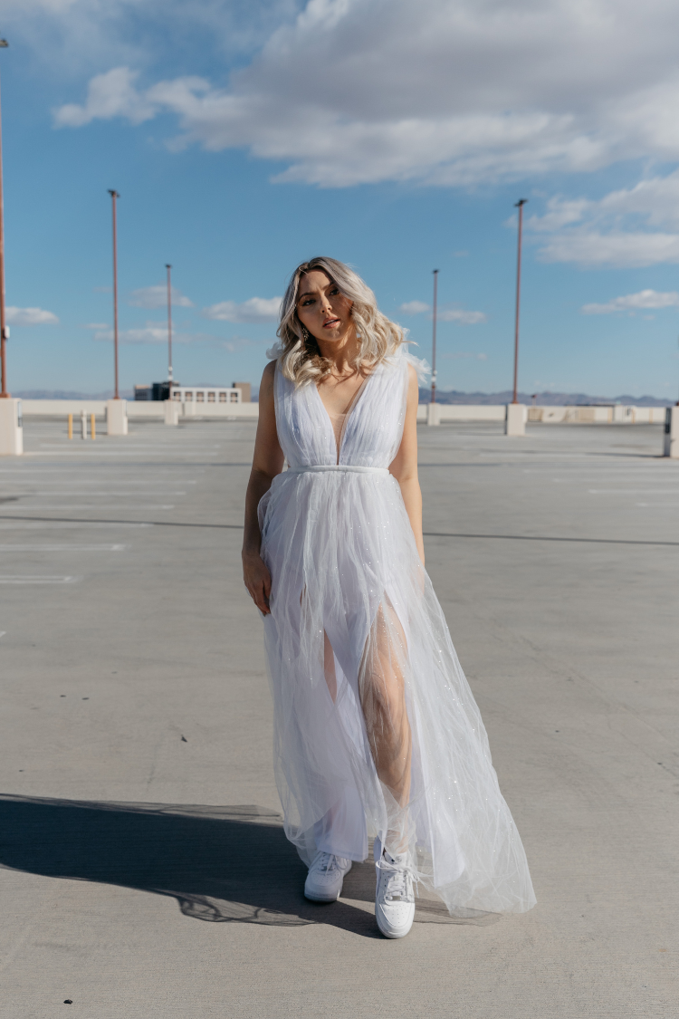 white tulle maxi dress with deep v and decorative shoulder detail