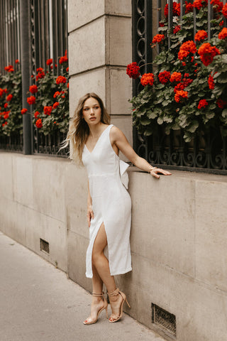 white sequin sheath dress with bow back detail for engagement photos in paris