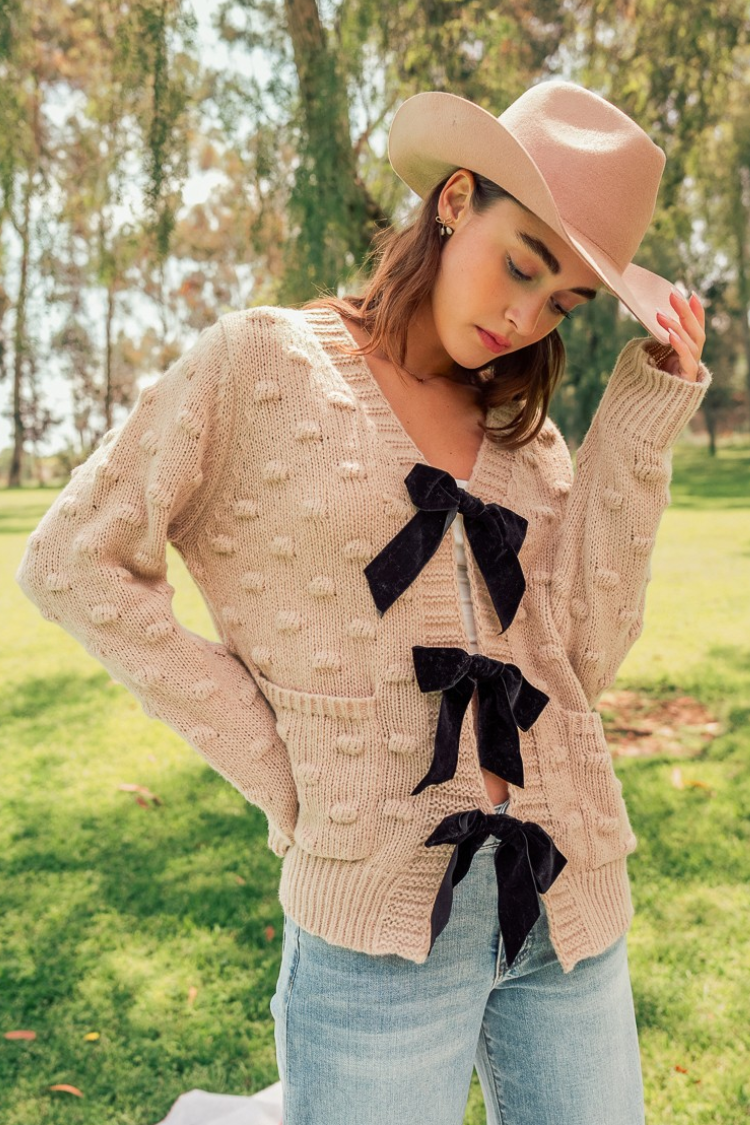 camel sweater with black bows