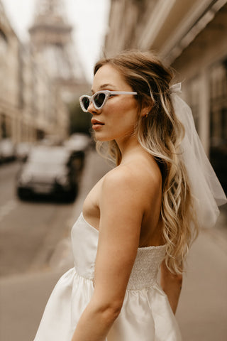 white tiered satin mini dress for paris engagement photos