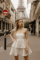 white tiered satin mini dress for paris engagement photos