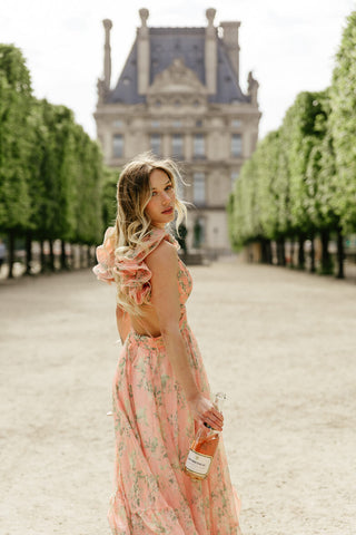 coral floral dress with bold ruffle shoulder for paris engagement photos