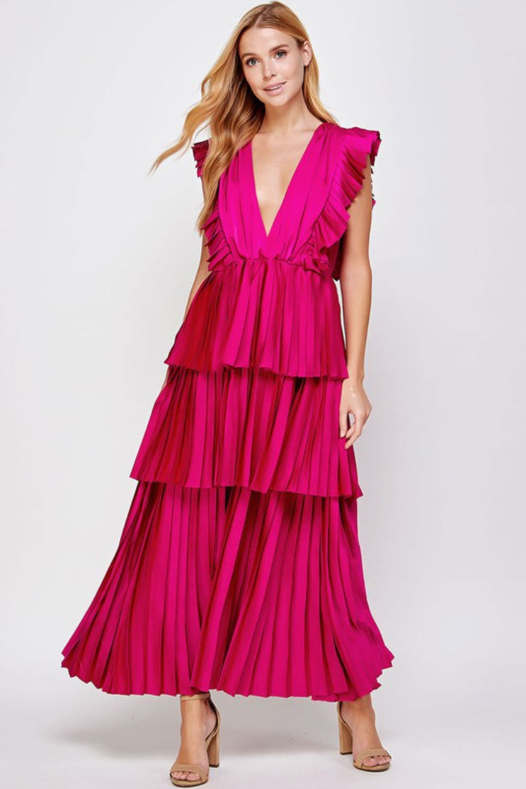 a model in a pink tiered maxi dress facing the front.