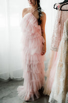 a neck-down photo of a model in a pink tulle dress.