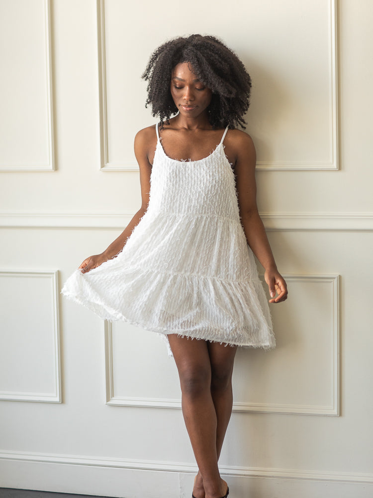 white 3d feather embellished mini dress with spaghetti straps and a bow back